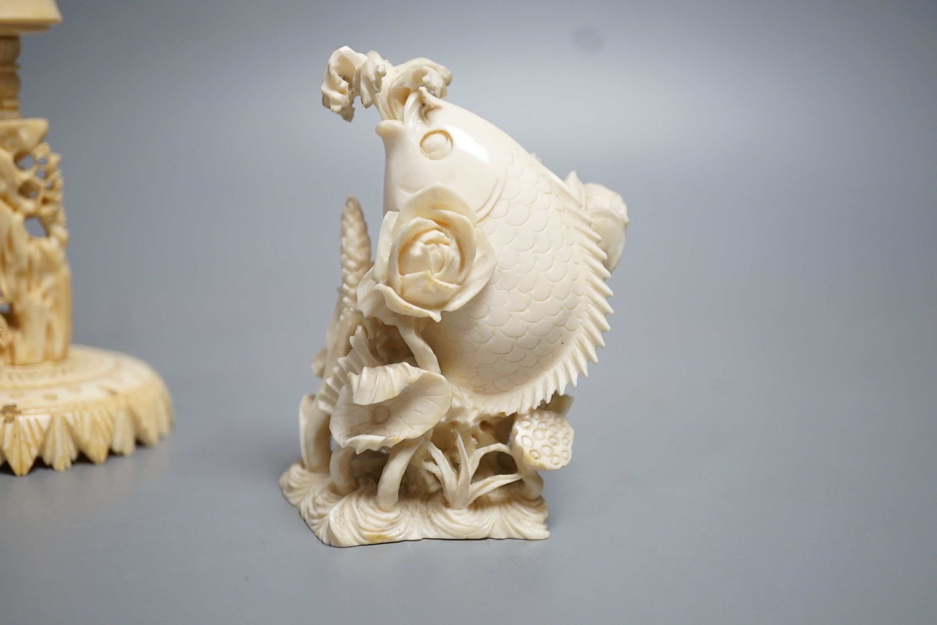 A Chinese ivory concentric puzzle ball and stand, two Chinese ivory snuff bottles and stoppers, modelled as a leaping carp and as cicadas on a nut, early 20th century